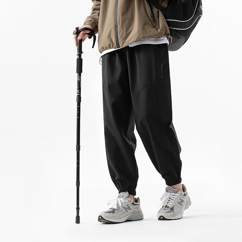 Functional waterproof charging pants spring and autumn loose tied feet casual breathable sports pants outdoor mountaineering trousers