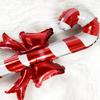 Christmas bows, candy canes, aluminum foil balloons with red and white stripes for a happy Christmas and New Year outfit