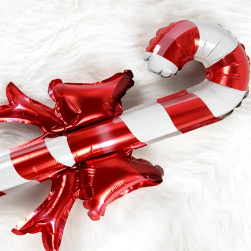 Christmas bows, candy canes, aluminum foil balloons with red and white stripes for a happy Christmas and New Year outfit