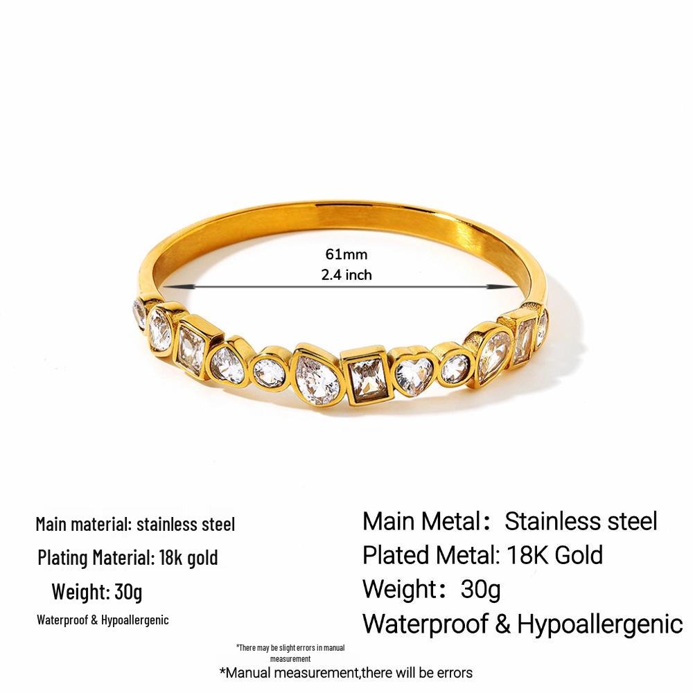 Женский браслет Ying Tai с нерегулярными цирконами - Нержавеющая и титановая сталь, Высокополированное вакуумное покрытие 18 карат золотом.