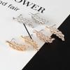 European Fashion Silver Needle Leaf Stud Earrings with Symmetrical Hollow Design and Modern Elegance