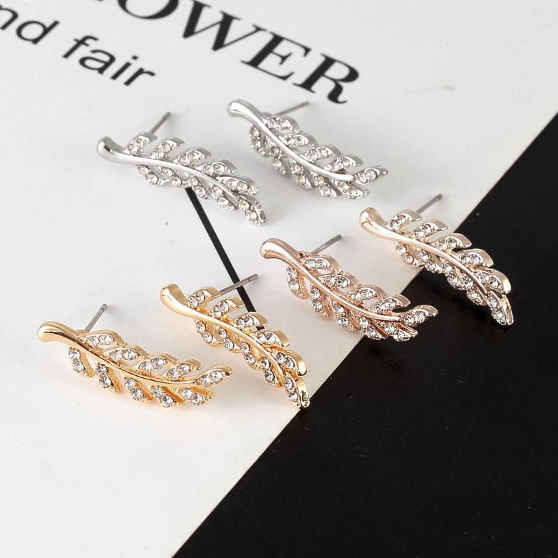European Fashion Silver Needle Leaf Stud Earrings with Symmetrical Hollow Design and Modern Elegance