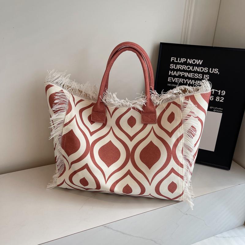 2026 Damen-Tragetasche für Reisen Strandtasche Große Kapazität Schulter-Pendlertaschen Hand-Quaste Jeans-Print Quaste Gespleißte Handtaschen