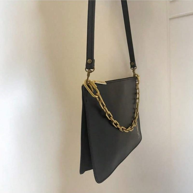 YSL black makeup crossbody bag with chain detailing, portable design, and large capacity, suitable for everyday use and travel.