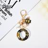 Talos Black Series Keychain Pendant, Dried Flower Initial Letter Charm Key Chain with Bee Tassel Design, A-Z Holder for Bag Purse Backpack