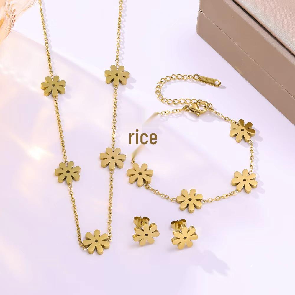 Elegant Gold-Plated Stainless Steel Daisy Jewelry Set: Necklace, Bracelet, and Earrings.