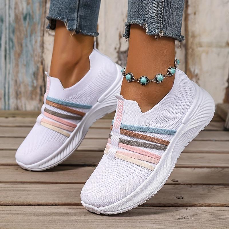 The Lady Wears Slip-On Casual Sports Shoes, Featuring a Breathable Mesh Design with Pastel Stripes, Suitable for Tennis And Comfortable