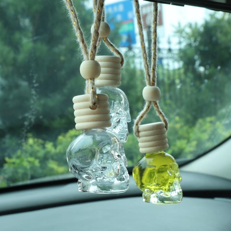 Auto-Lufterfrischer-Diffusor, Aromatherapie-Flasche mit ätherischen Ölen, zum Aufhängen, transparente Totenkopf-Parfümflasche, reinigendes Autozubehör