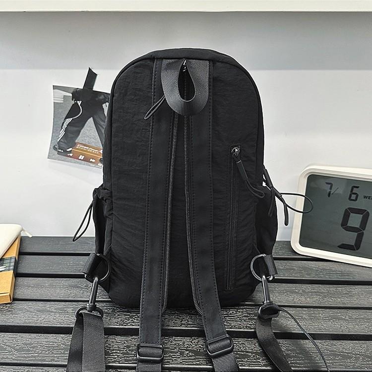 School bag Solid color outdoor mountaineering waterproof pleated backpack Lightweight leisure travel messenger bag Niche versatile simple breast bag