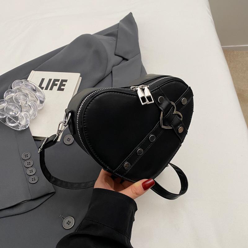 

2024 ранняя весна новая популярная мода заклепки однотонный косой спан сумка нишевый дизайн иностранный стиль любовь одно плечо женская сумка прилив чёрный
