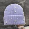 Autumn and winter new pearl bow light luxury wool hat women's big head circumference shows a small face, cold-proof ear protection knitted hat