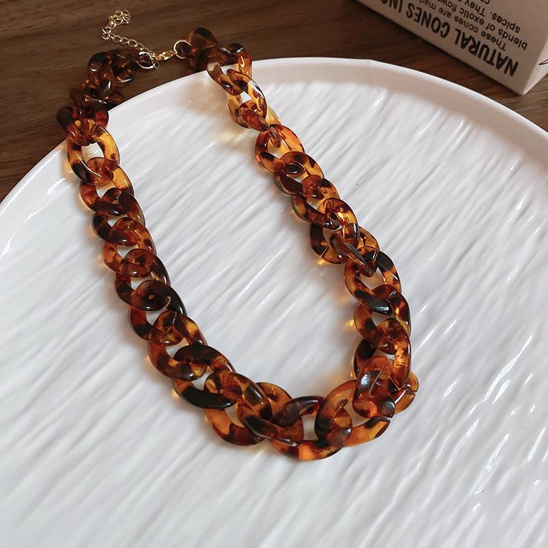 Meillard Leopard Print Jewelry Set: Interlocking Earrings, Necklace, Bracelet, and Ear Studs.