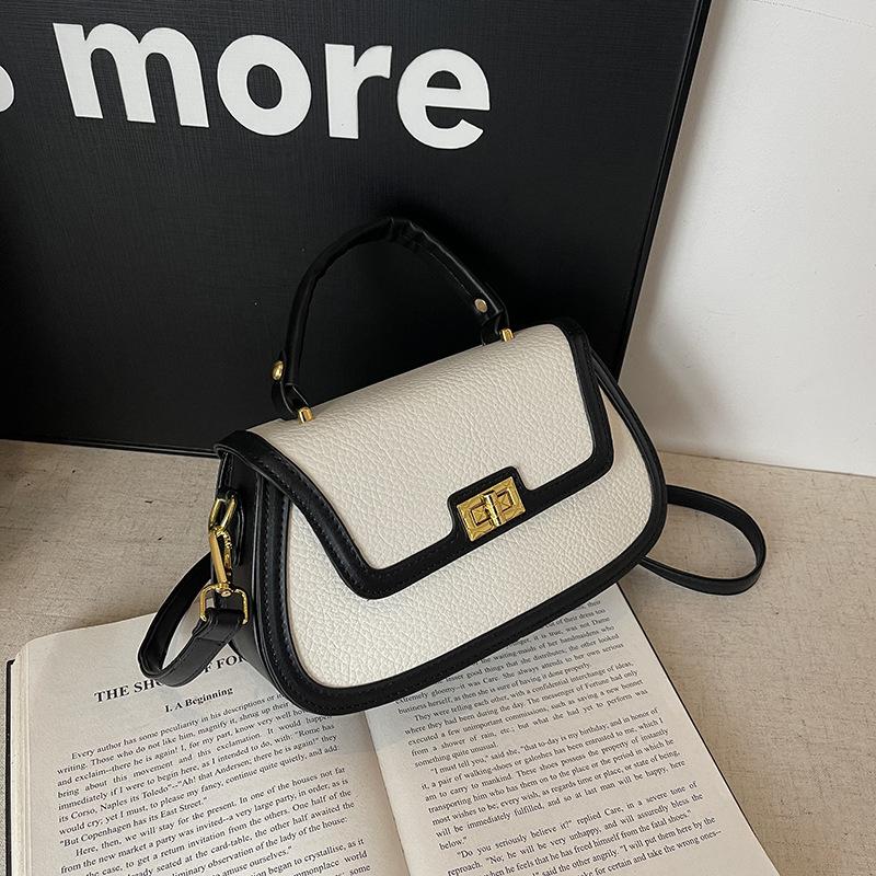 Spring niche design fashionable contrasting color saddle bag portable shoulder crossbody trendy women's bag