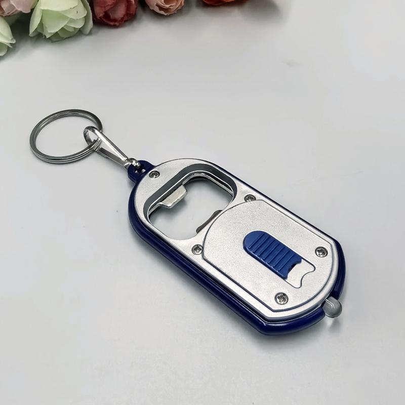 Ouvre-bouteille LED Multifonctionnel Mini Lampe de Poche Illuminée Porte-clés Pendentif