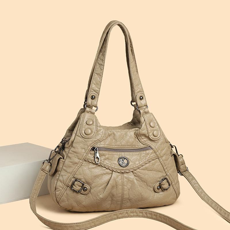 Shoulder leather locomotive bag New large-capacity women's bag Atmospheric commuter bag Woven leather button pleated bag