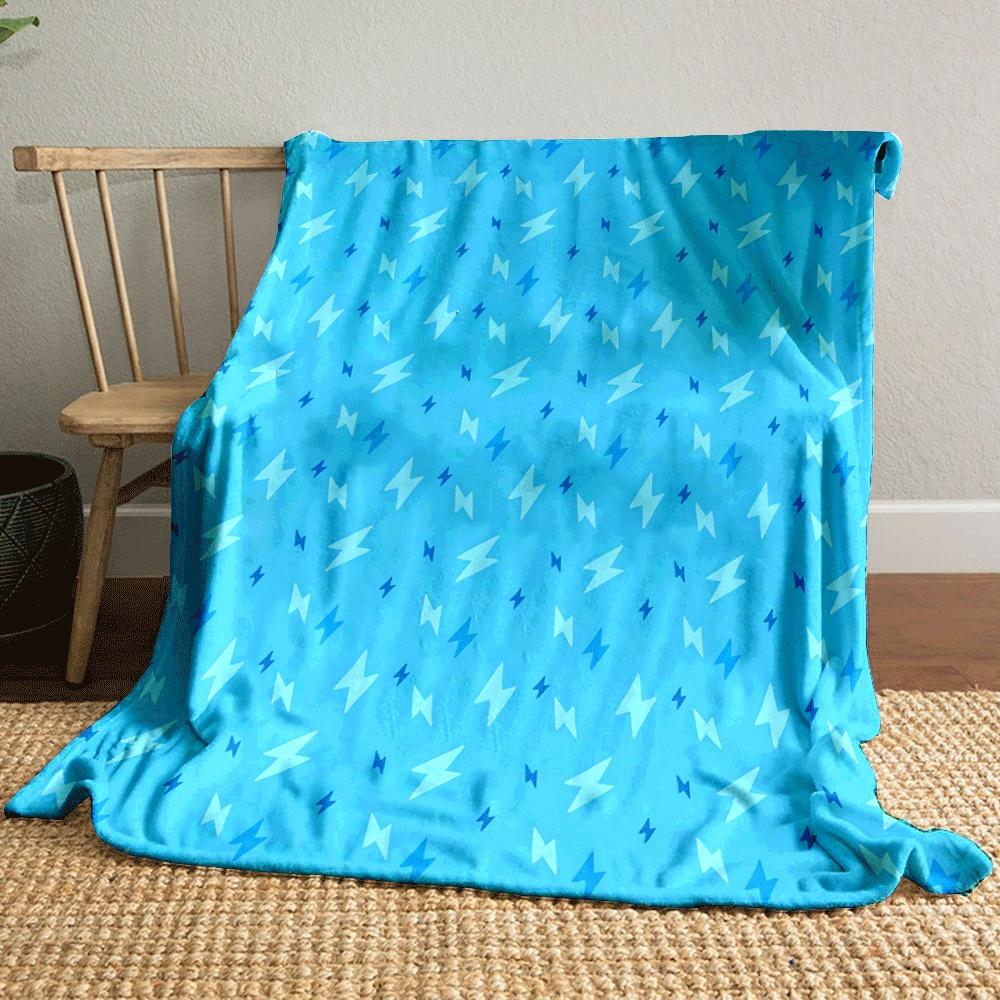 The pattern consists of scattered lightning bolt shapes in varying blue tones. for all seasons blanket lunch break throw gift