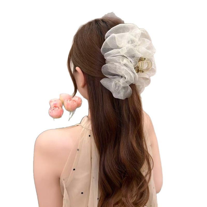 The Mesh Grabber Is Elegant and Feminine with A Lot of Hair On The Back of The Head. It Is A Shark Clip Hair Accessory