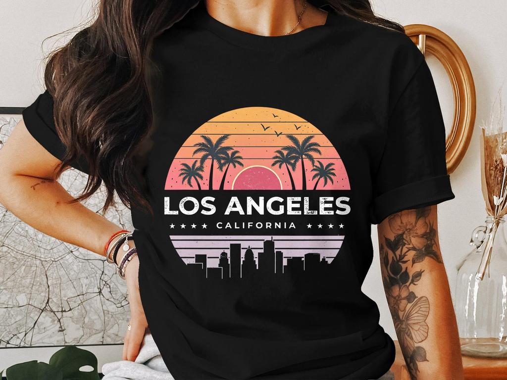 Los Angeles cityscape retro design t-shirt, vintage sunset graphic tee, palm trees urban style, west coast vibes shirt