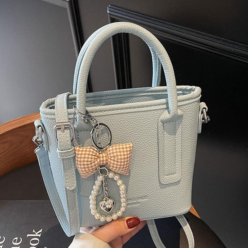 Spring and summer popular solid color simple high quality lychee pattern portable bucket bag women's fashion versatile commuter messenger bag