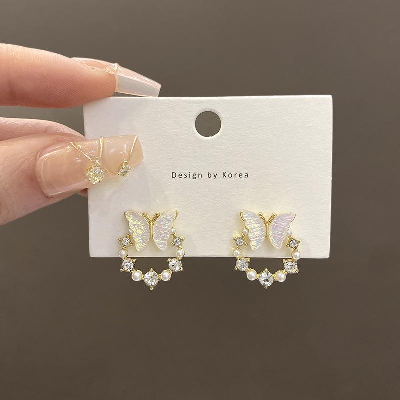 

Silver needle super fairy shell butterfly earrings women s niche design sense rhinestone pearl stud earrings ins wind personalized earrings