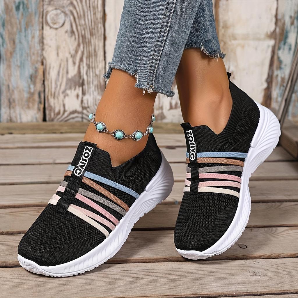 The Lady Wears Slip-On Casual Sports Shoes, Featuring a Breathable Mesh Design with Pastel Stripes, Suitable for Tennis And Comfortable