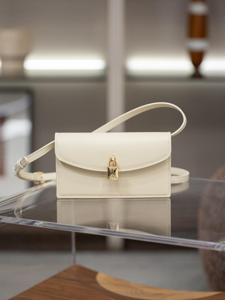A Small Square Canvas Women's Bag with a Unique Lock and a Light Luxury Style Made of Cowhide