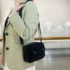 Neutral men's and women's cross-body bag with shoulder strap, made of corduroy material, with a flap design  the outside.