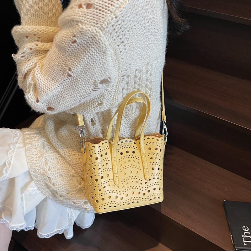 Neue High-End-Nische hohl geschnitzt vielseitiger Gemüsekorb Damenhandtasche Schulter Crossbody kleine Tasche Bucket Bag