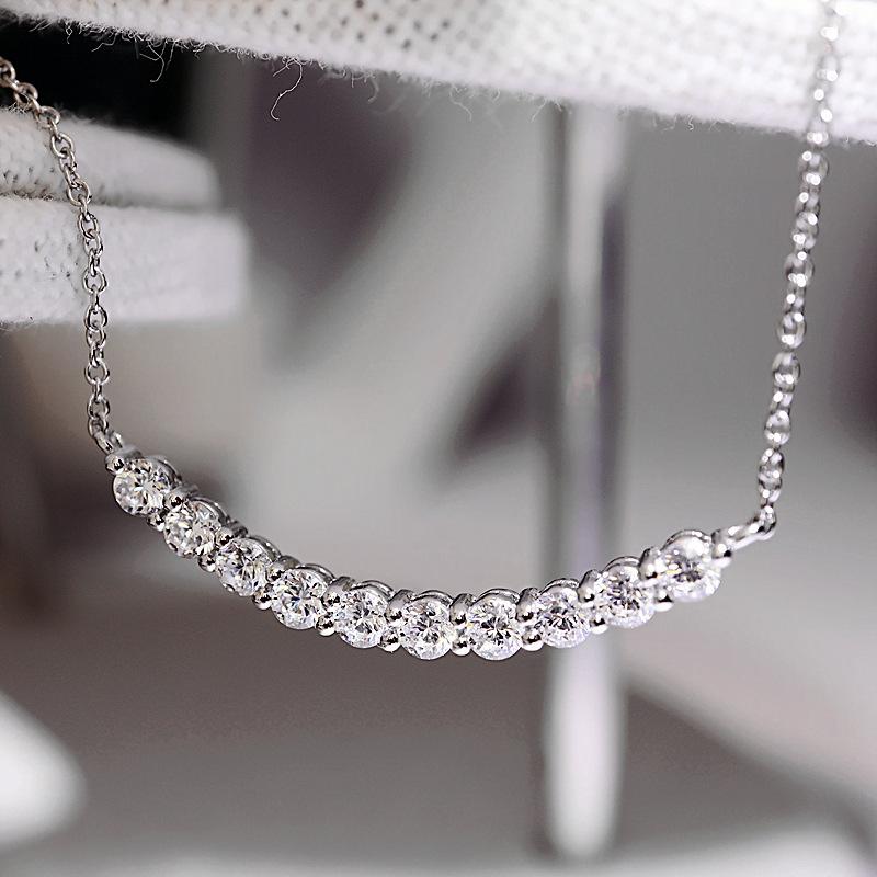 Curved smile pendant necklace, set with zircon stones
