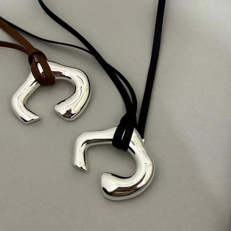 Brown Leather Cord Necklace with Silver Abstract Human Body Pendant – Autumn/Winter Light Luxury Clavicle Chain