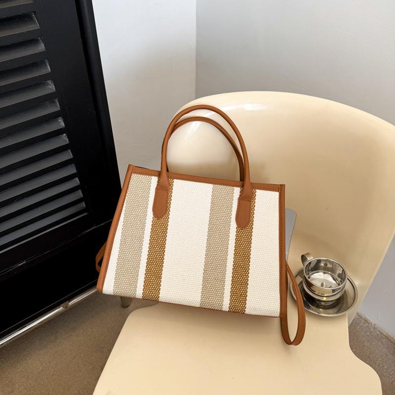 

Commuter contrasting striped handbag bag women s fashion messenger bag new women s versatile bag