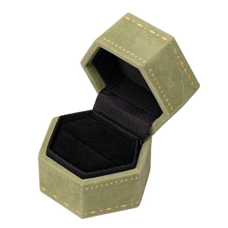 Hexagonal Ring Presentation Box with Black Interior, Gold-Tone Border Pattern, and Attached Lid for Retail Display