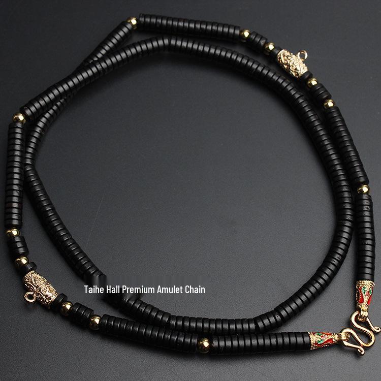 

Сохраняющее цвет прочное кокосовое ожерелье с кулоном-амулетом из Таиланда - Доступно в вариантах из одной или трех нитей Default