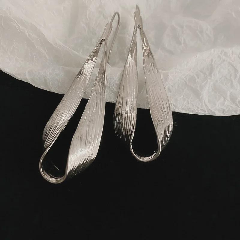 "Exquisite Metallic Leaf Drop Earrings: European & American Style, Trendy and Unique Design for Women."