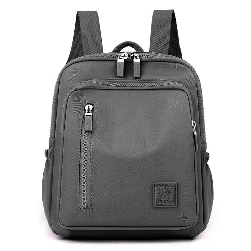 

Женские плечи, свежий, милый, стильный и простой нейлоновый однотонный дорожный рюкзак серый