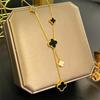 European & American Trendy Hollow Four-Leaf Clover Necklace with Black Shell Tassel Pendant.