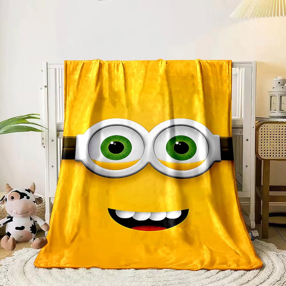 

Bright yellow face with green eyes, goggles, and a wide smile pattern. for all seasons blanket lunch break throw gift 80cm x 120cm