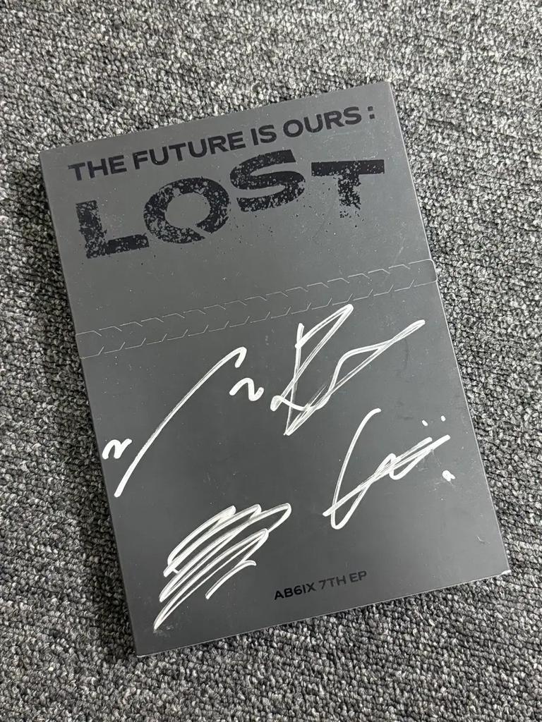This is a sale of AB6IX's 7th EP, LOST, with handwritten signatures.