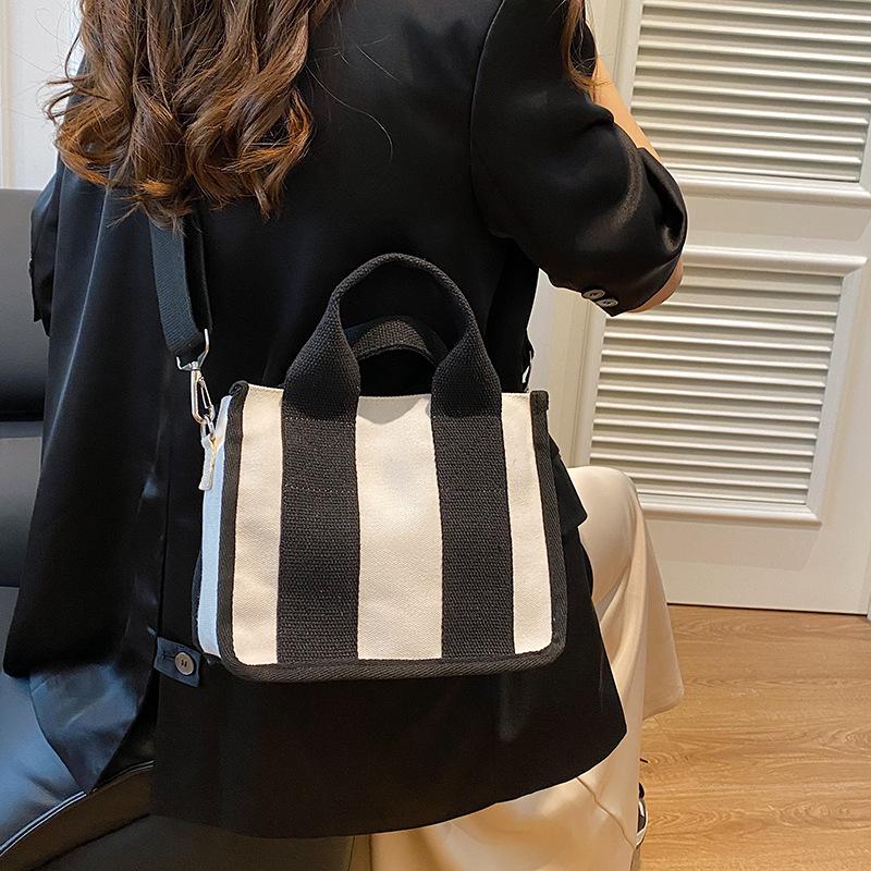 2025 fashion new women's bag niche design color matching canvas bag foreign style portable magnetic buckle bag versatile shoulder bag tide