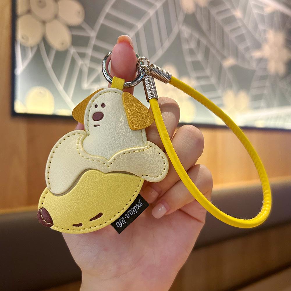 Creative Cartoon Mango Pudding Dog Leather Keychain - Cute Fruit Pendant for Girls' Bags.