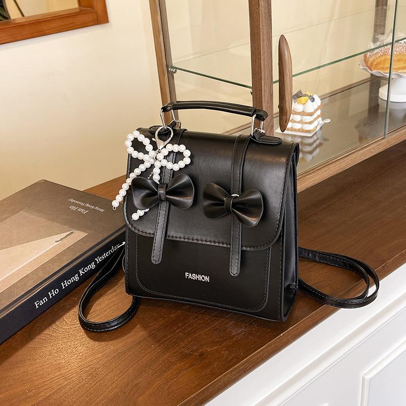 South Korea solid color college style commuter backpack women 2025 new trend bow portable shoulder messenger bag