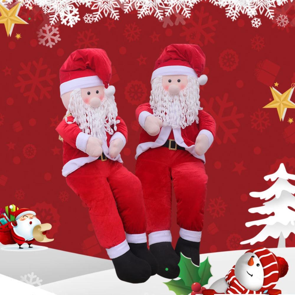 Rekwizyty Świętego Mikołaja, wózek z reniferami w pozycji siedzącej, Święty Mikołaj niosący paczkę z prezentami, świąteczna dekoracja okienna scena