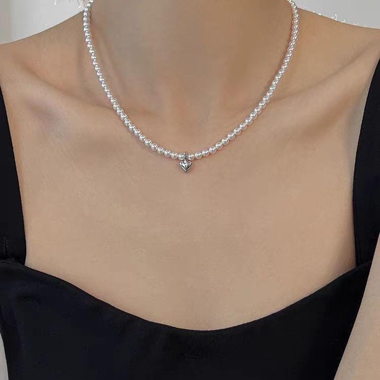 

Елегантне мідне кольє-чокер з перлами у формі серця NK-97 - Універсальний французький стиль для жінок