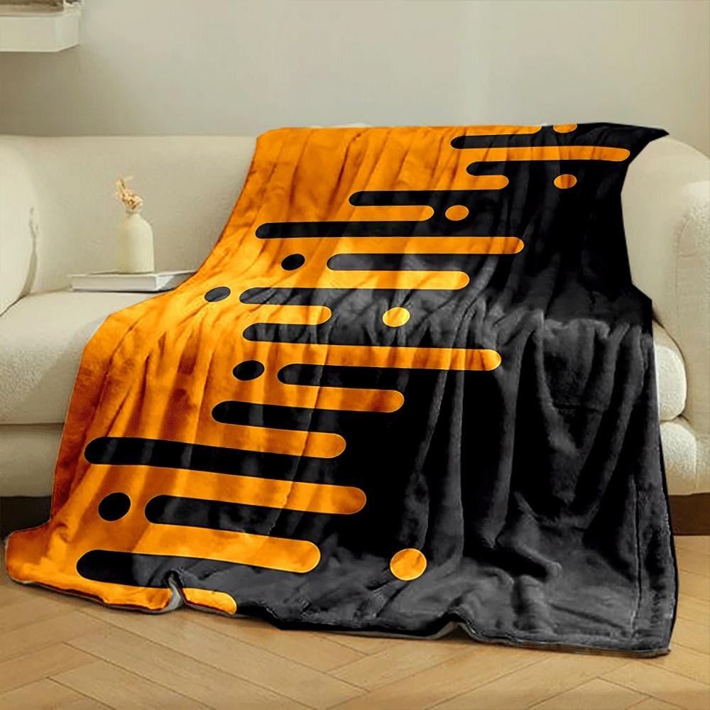 Orange elongated bars and circles merge into a black background diagonally. for all seasons blanket lunch break throw gift