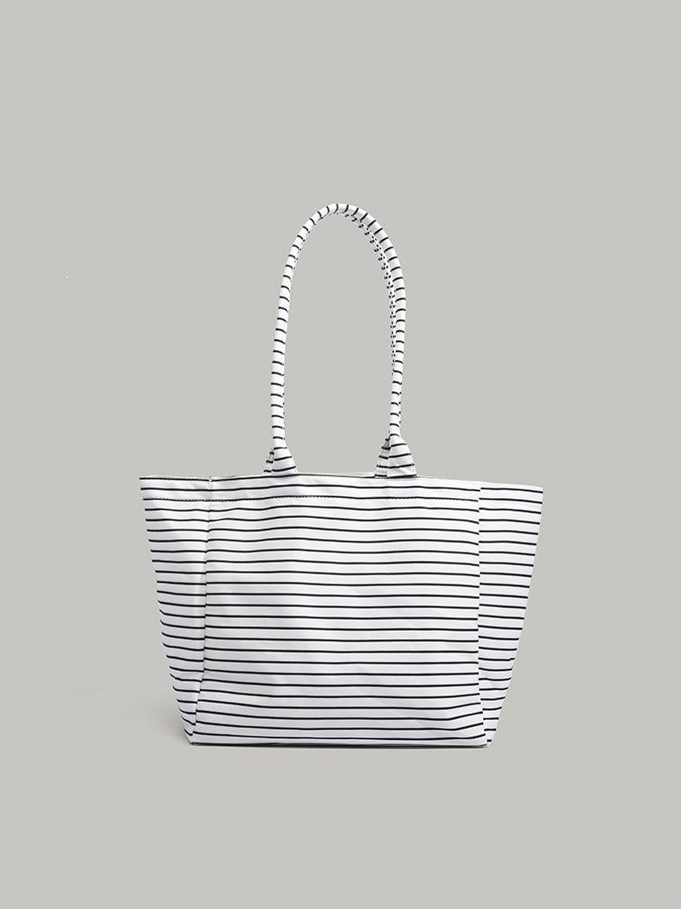

Summer niche design handheld tote bag women s 2025 new simple striped canvas bag large capacity commuter bag