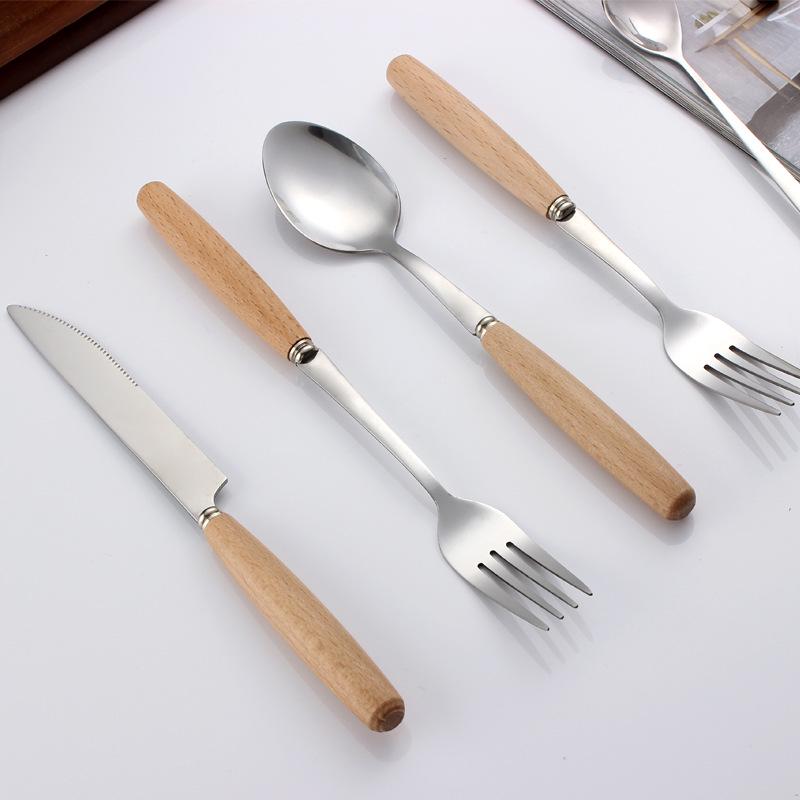 Western Cutlery Set: Stainless Steel with Wooden Handles - Includes Steak Knives, Dessert Spoons, Pasta Forks, and Spoons.