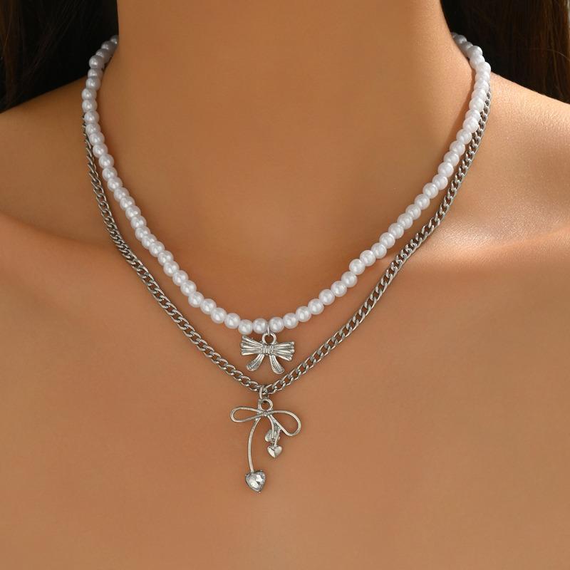 Alloy hollow bow pendant stacked with simple temperament pearl necklace light luxury niche design