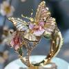 Anello aperto a forma di farfalla e fiore in lega alla moda con strass incastonati per donna