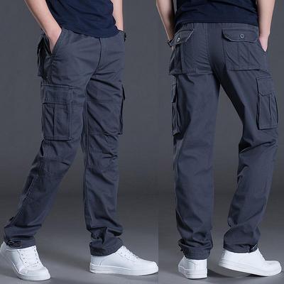 Pantalones de trabajo de algodón holgados con múltiples bolsillos para hombre, ideales para primavera. Tallas grandes, alta calidad y estilo moderno.
