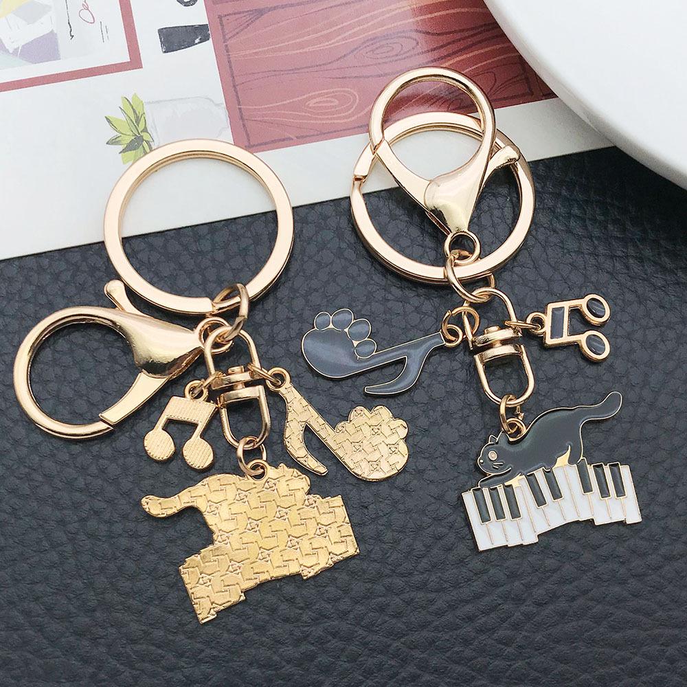 Well-Behaved Black Cat Zinc Alloy Keychain: Cute Drip Oil Cartoon Pendant for Backpacks
